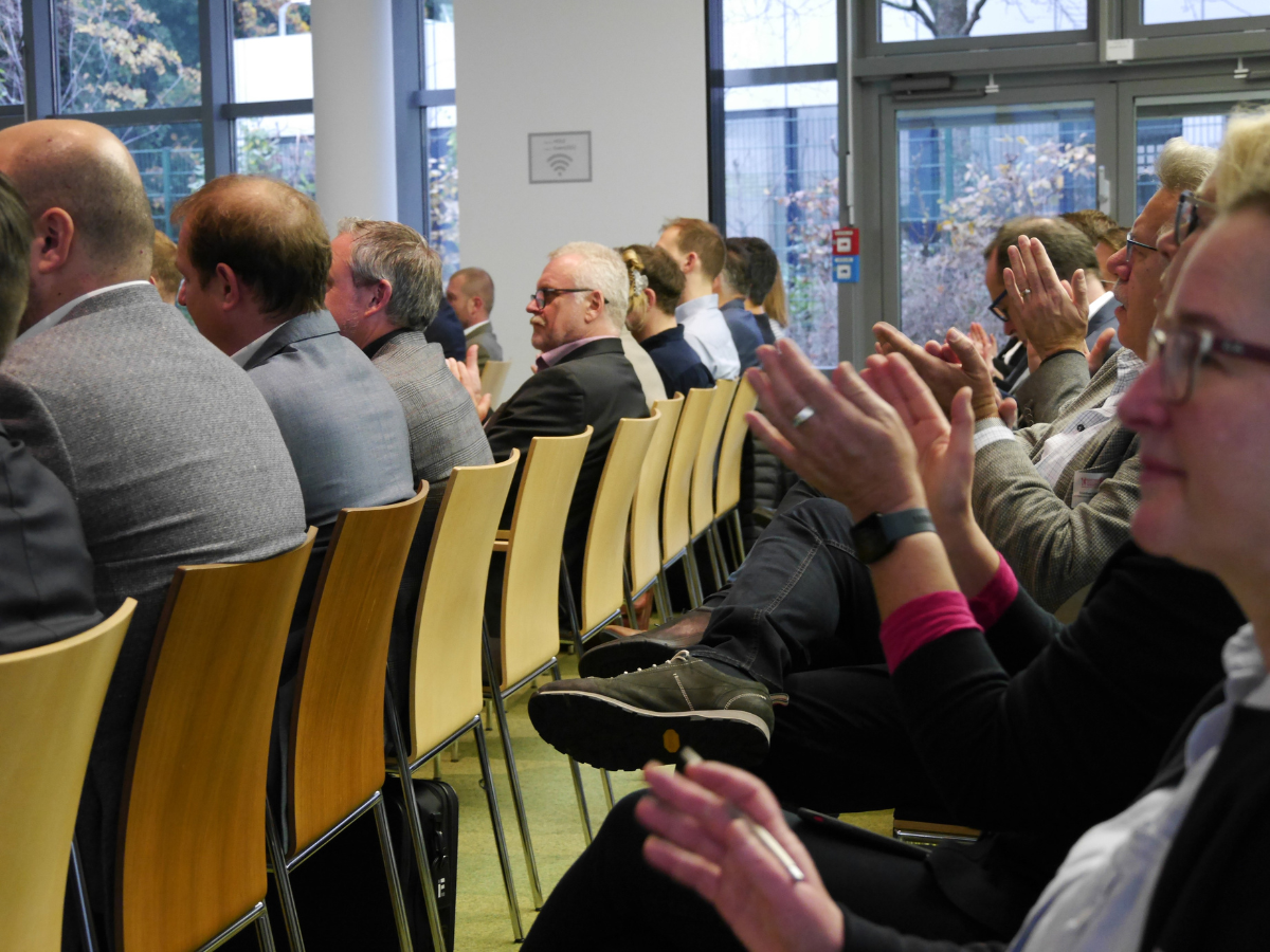 Eine Reihe von Zuhörenden im Saal
